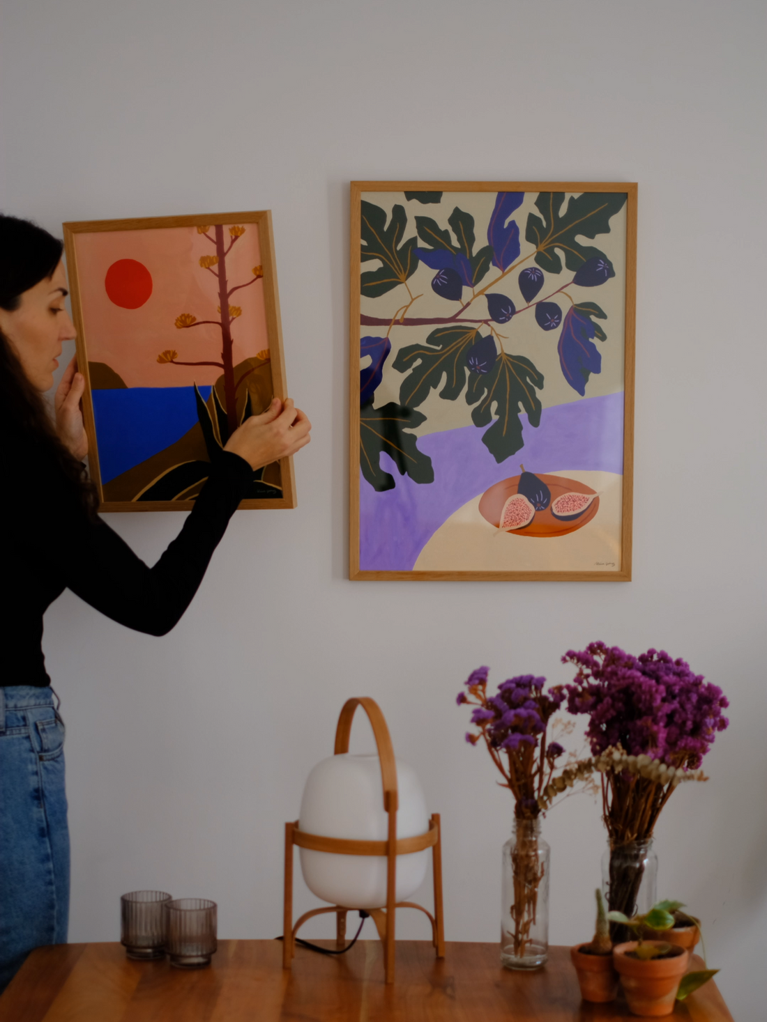 hanging prints on her empty wall